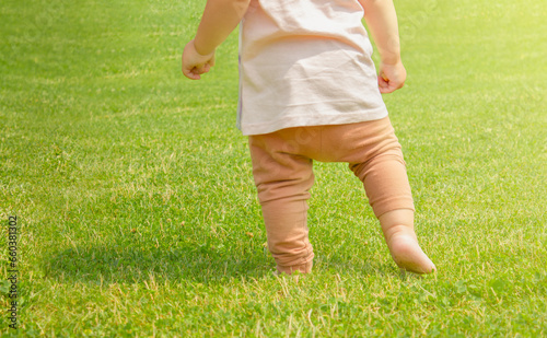 A one-year-old child is learning to walk