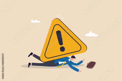 Caution or mistake attention, risk alarm with exclamation point symbol, error or failure warning, bankruptcy notice alert, problem attention concept, frustrated businessman fall under attention sign. photo
