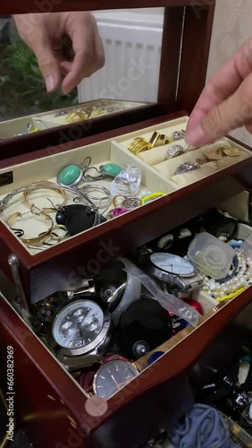 woman hands take knick-knackery rings earrings neckless