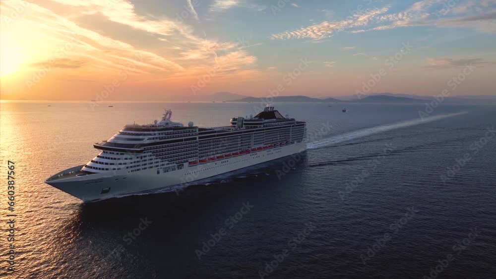 Panoramic aerial view of a cruise ship traveling over the ocean during golden summer sunset time Panoramic aerial view of a cruise ship traveling over the ocean during golden summer sunset time