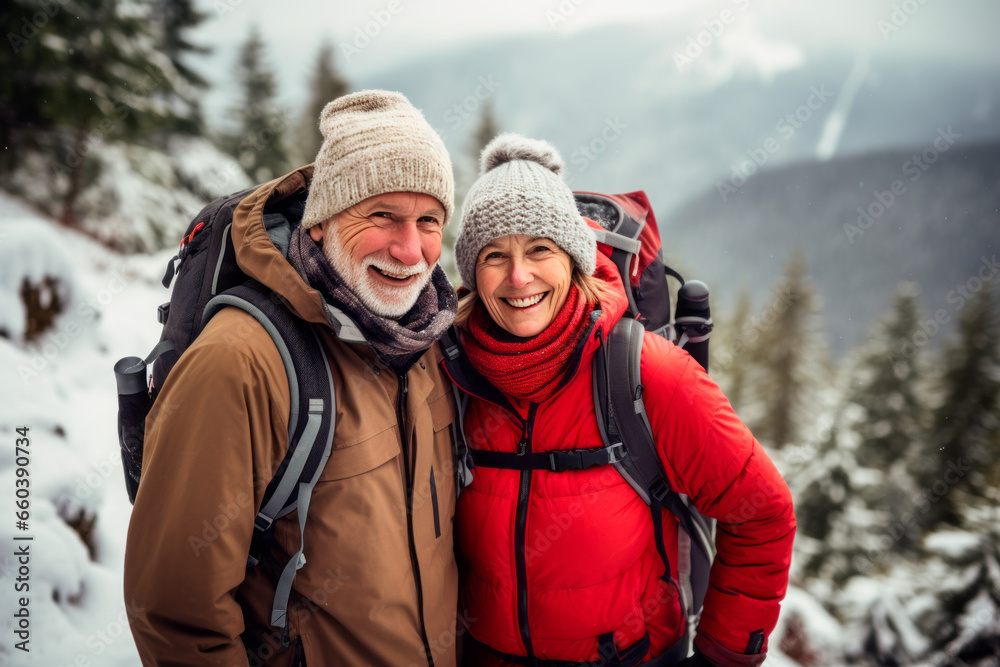Senior couple while winter hiking, filled with wonder at the beauty of nature during their active retirement Senior couple while winter hiking, filled with wonder at the beauty of nature during their active retirement