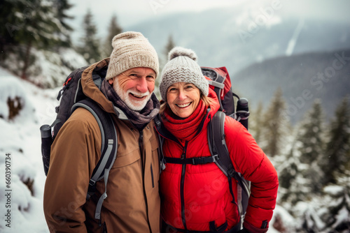 Senior couple while winter hiking  filled with wonder at the beauty of nature during their active retirement