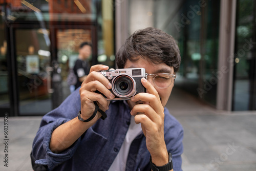 tourist man takes photos with a camera in the city of london © PintoArt