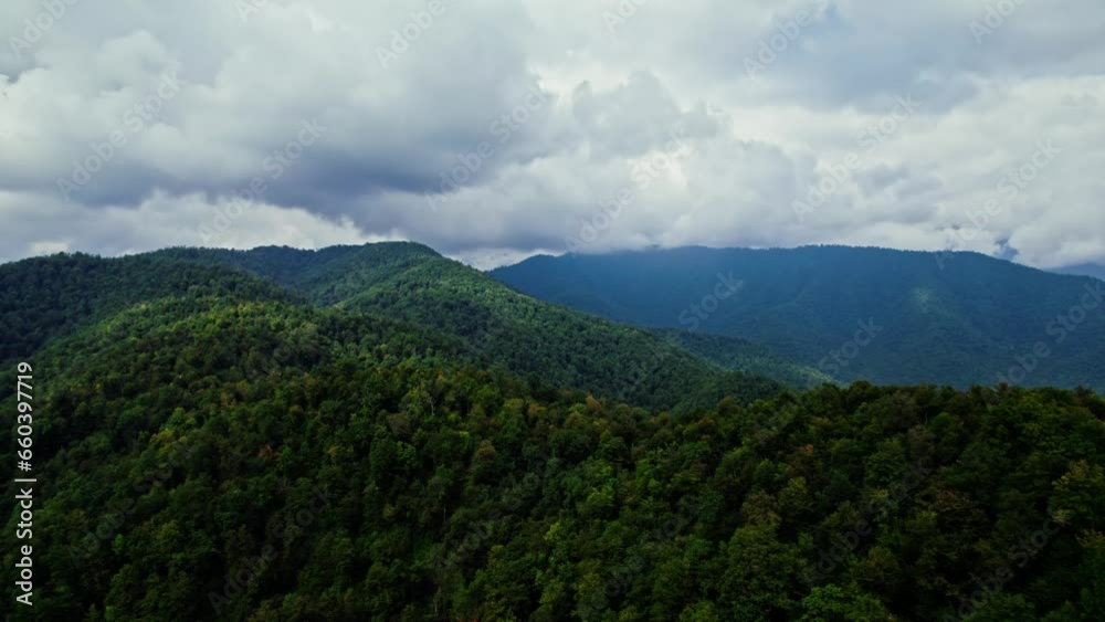 Aerial view of green forest and mountains with clouds.Georgia. cloudy weather Aerial view of green forest and mountains with clouds.Georgia. cloudy weather
