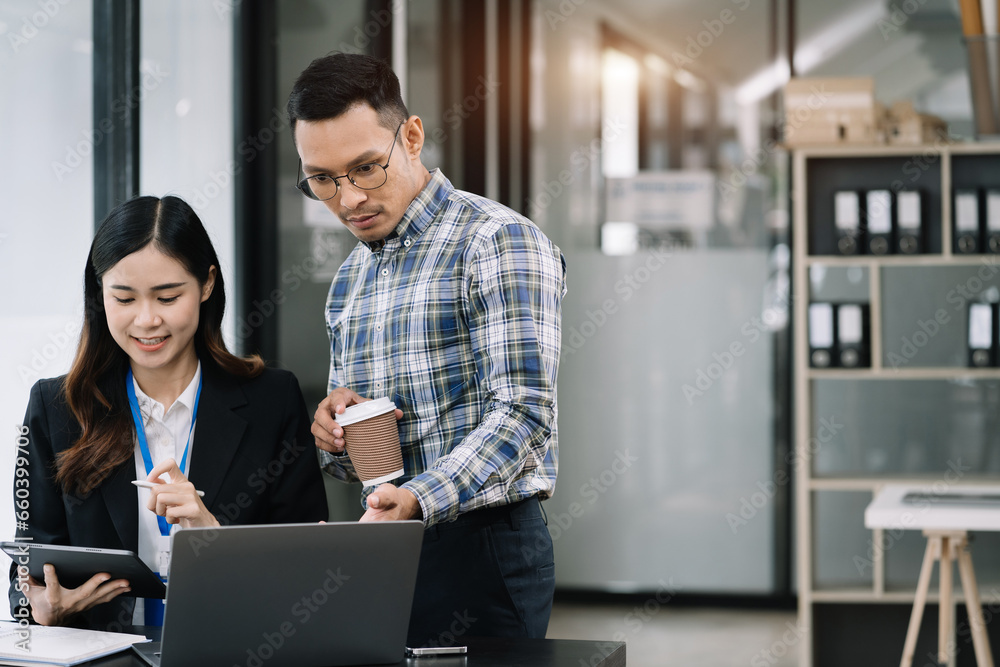 Businessmen team or financial data analysts working with tablets and laptop computers and data graphs together. Plan to analyzing projects in the office.