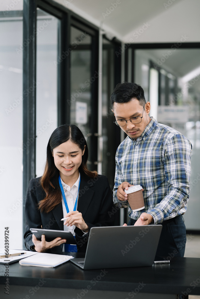 Businessmen team or financial data analysts working with tablets and laptop computers and data graphs together. Plan to analyzing projects in the office.