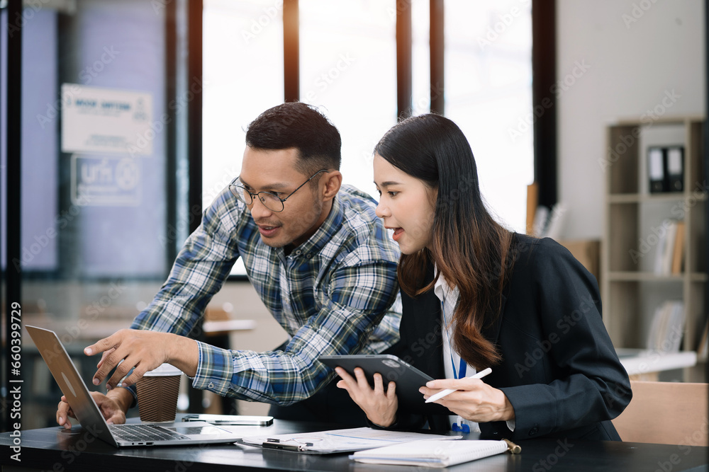 Businessmen team or financial data analysts working with tablets and laptop computers and data graphs together. Plan to analyzing projects in the office.