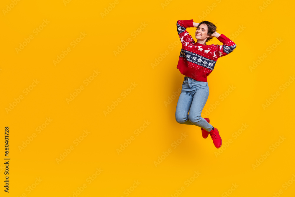 Full length photo of adorable gorgeous cool girl dressed red jumper flying hold hands behind head isolated on yellow color background Full length photo of adorable gorgeous cool girl dressed red jumper flying hold hands behind head isolated on yellow color background