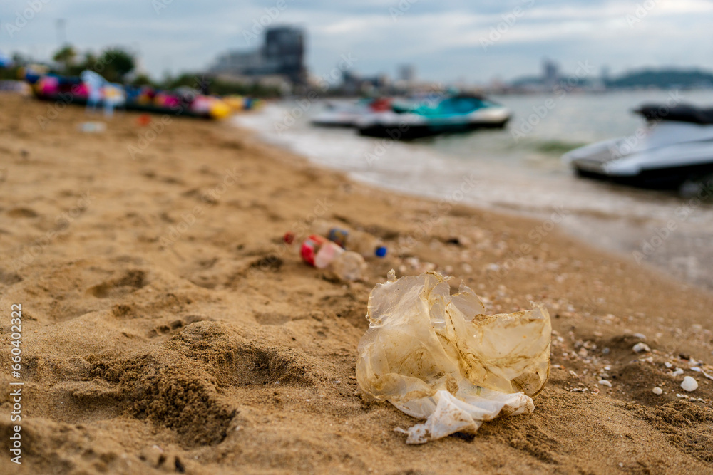 Plastic waste on the beach against city scape. Plastic waste on the beach against city scape.