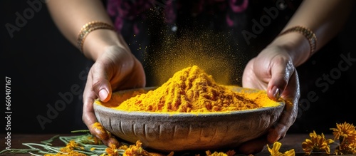 Traditional Indian kitchen preparing turmeric powder for curry an Ayurvedic antiseptic and antiviral spice with a stone mortar in Kerala India and Sri Lanka With copyspace for text