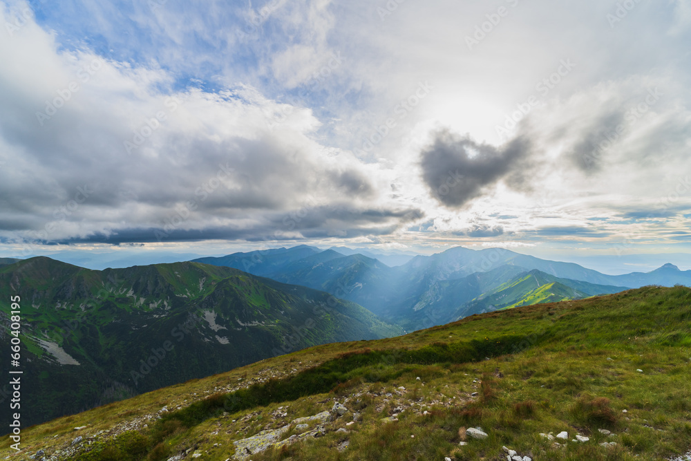Landscape high in the Polish Tatras, sun rays shining through the clouds.