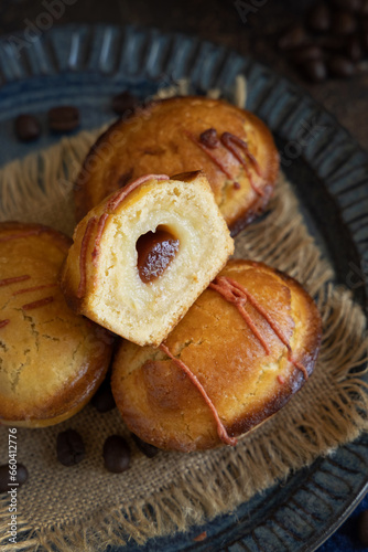 Pasticciotto leccese pastries on a dark blue plate on dark table close up photo