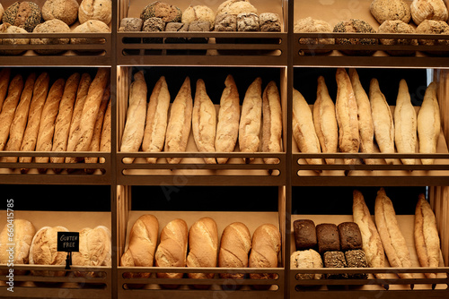 Background image of various fresh breads on shelf in artisan bakery with rustic setup, copy space