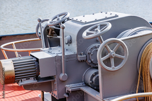 Фотография Closeup of levers, steering wheels, anchor windlass machine and heavy duty winch