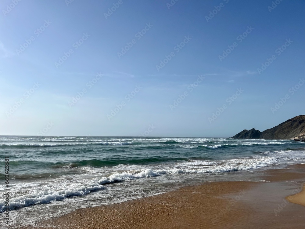 Waved ocean bay, sandy coast