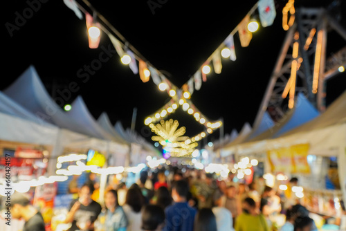 Blurred image of night market with people background, bokeh.(vintage sound) © Apicha