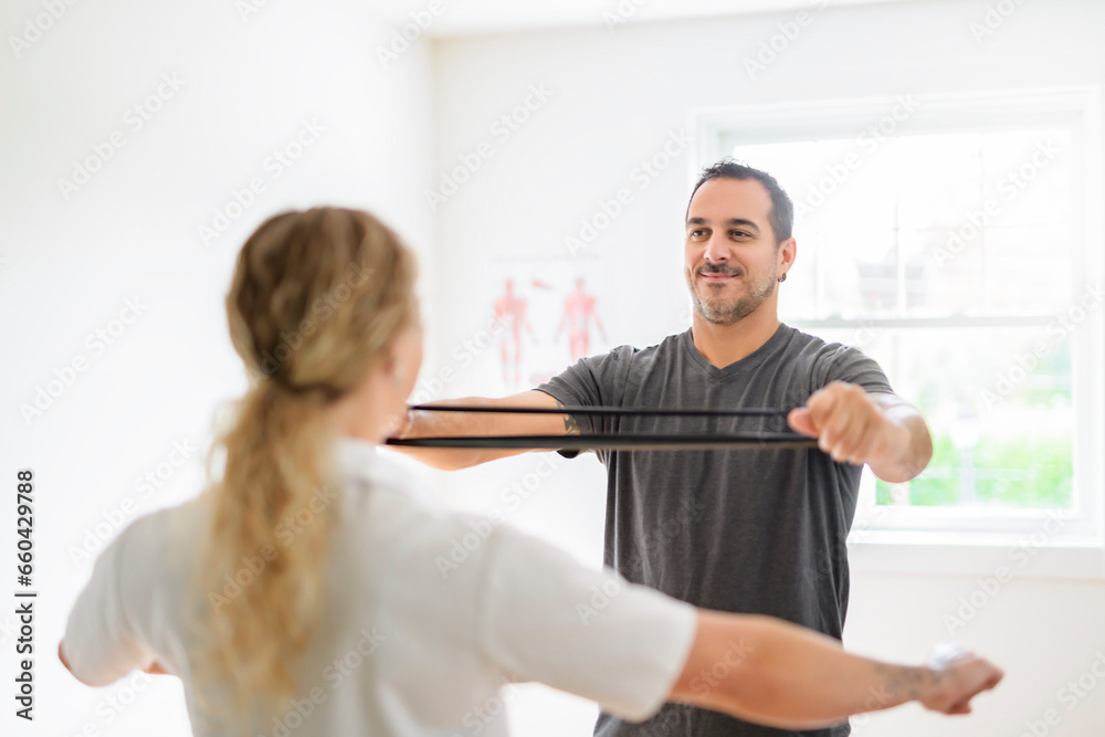 Fototapeta premium Modern rehabilitation physiotherapy woman with man client