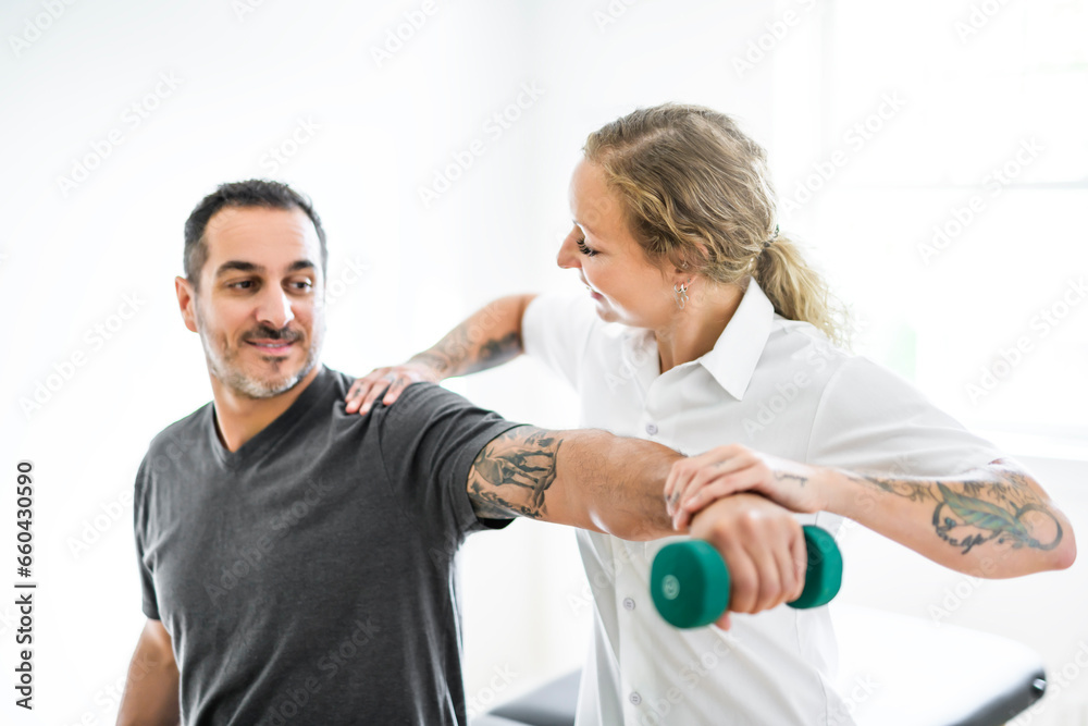 Modern rehabilitation physiotherapy woman with man client Modern rehabilitation physiotherapy woman with man client