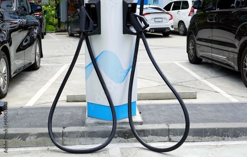 Close up the electric car charging station in the carpark in the gas station.