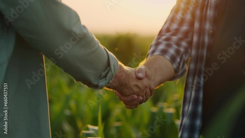 Handshake Of Two Farmers On Agricultural Fields, Closeup Of Hands, Big Deal in Agribusiness photo