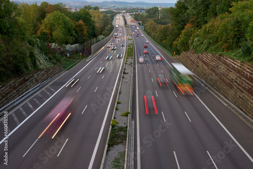 Long exposure photo of traffic with blurred traces from cars, top view. road, cars, blurred traffic, evening, top view. Highway at evening, blue hour illuminated by the traffic of cars