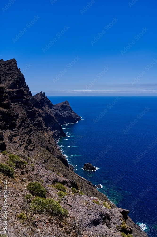 Scenic view of a rocky shoreline in a tranquil blue seascape