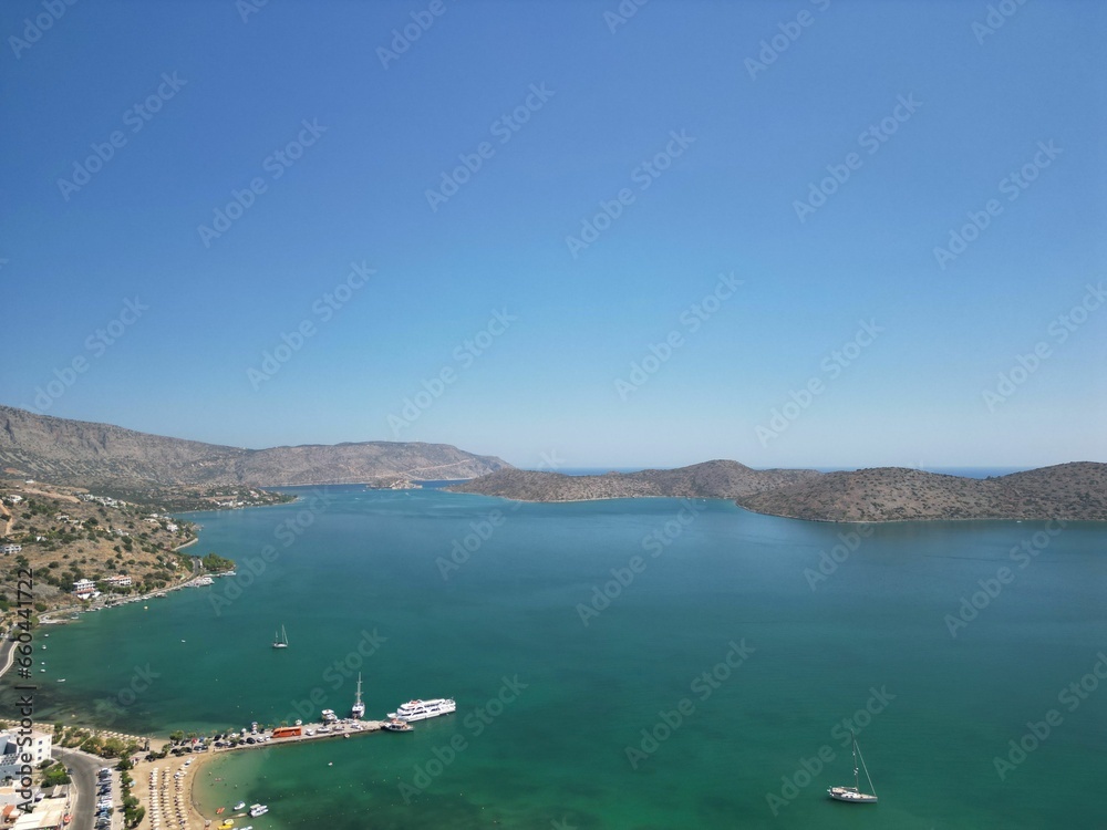 Aerial view of Elounda Bay on the Greek island of Crete with a boat sailing along the shore