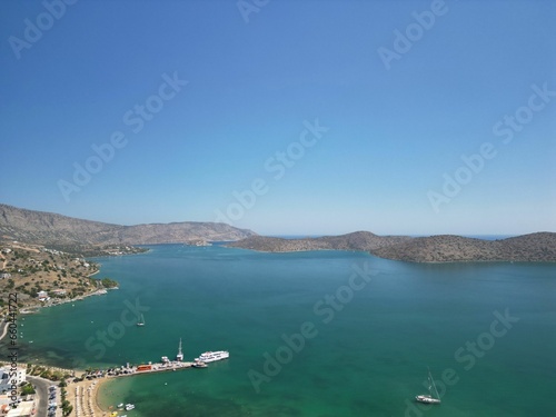 Aerial view of Elounda Bay on the Greek island of Crete with a boat sailing along the shore