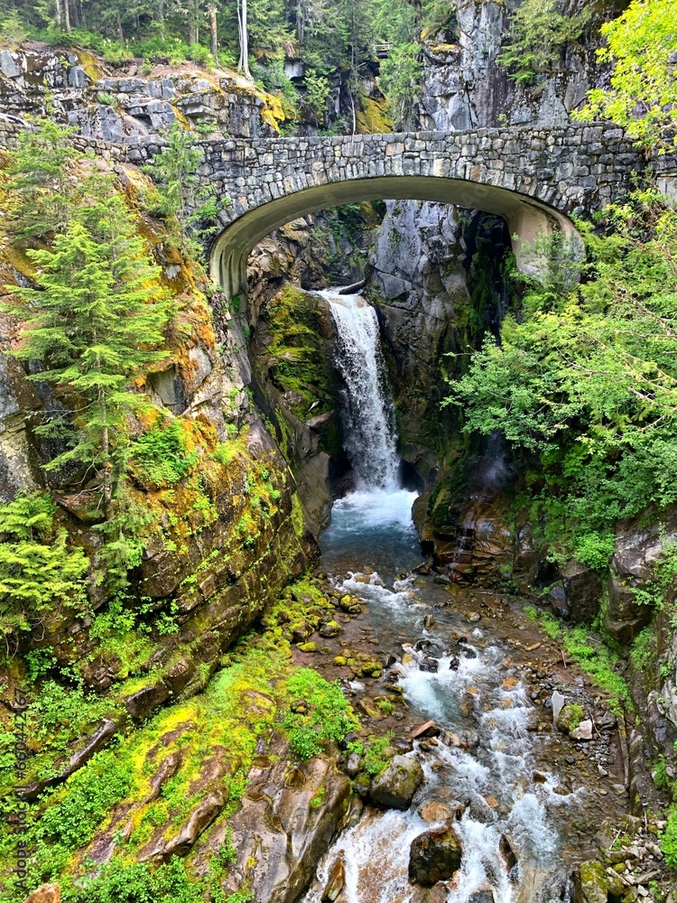 Majestic waterfall cascading underneath a bridge in Crater Lake National Park, Oregon, USA