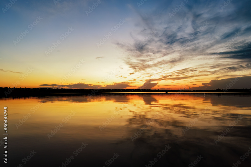 Vibrant sky reflecting on a calm and serene lake