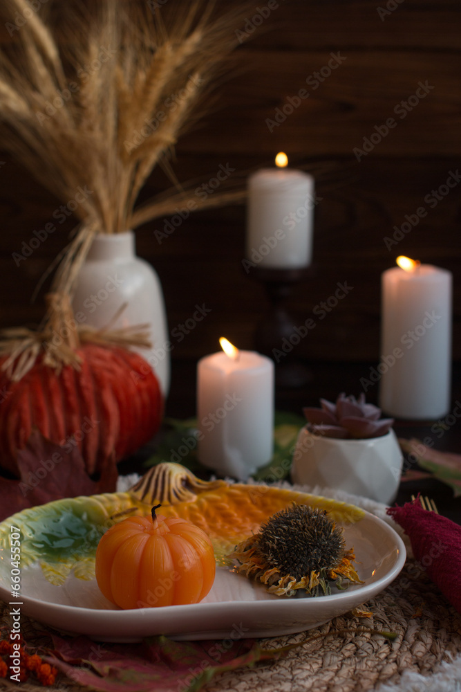 Autumn festive decor on the table. Romantic candlelit evening, Autumn festival and Halloween