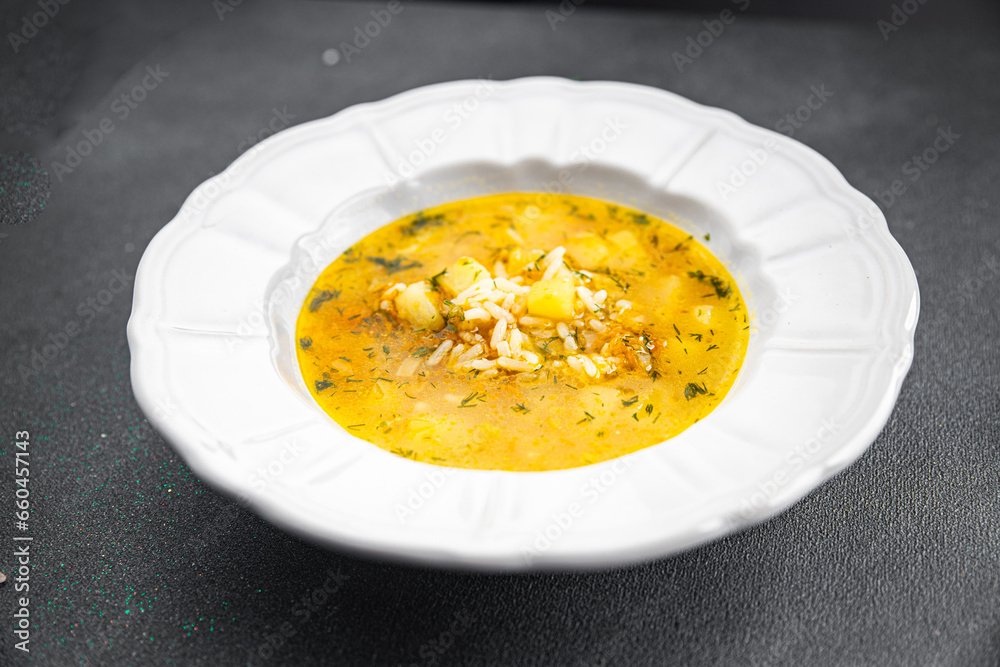 soup broth vegetables with rice, potatoe, carrot, onion eating cooking appetizer meal food snack on the table copy space food background rustic top view soup broth vegetables with rice, potatoe, carrot, onion eating cooking appetizer meal food snack on the table copy space food background rustic top view