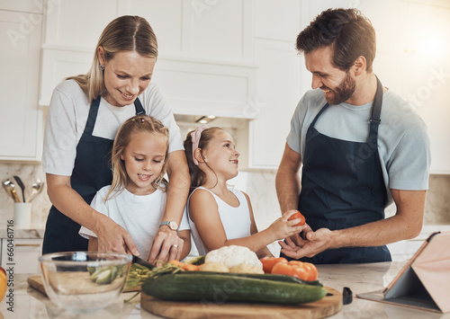 Love, cooking and family in the kitchen together for bonding and preparing dinner, lunch or supper. Happy, smile and girl children cutting vegetables or ingredients with parents for a meal at home.