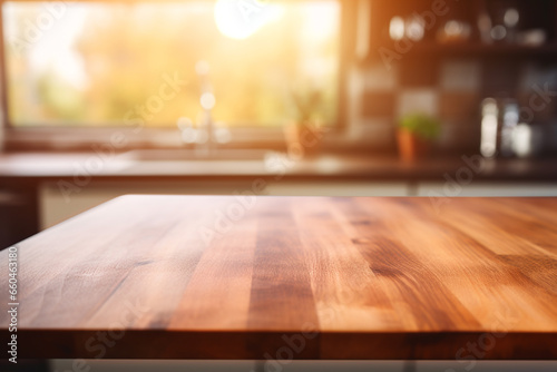 Top of surface wooden table with blurred modern kitchen background. © Golden House Images