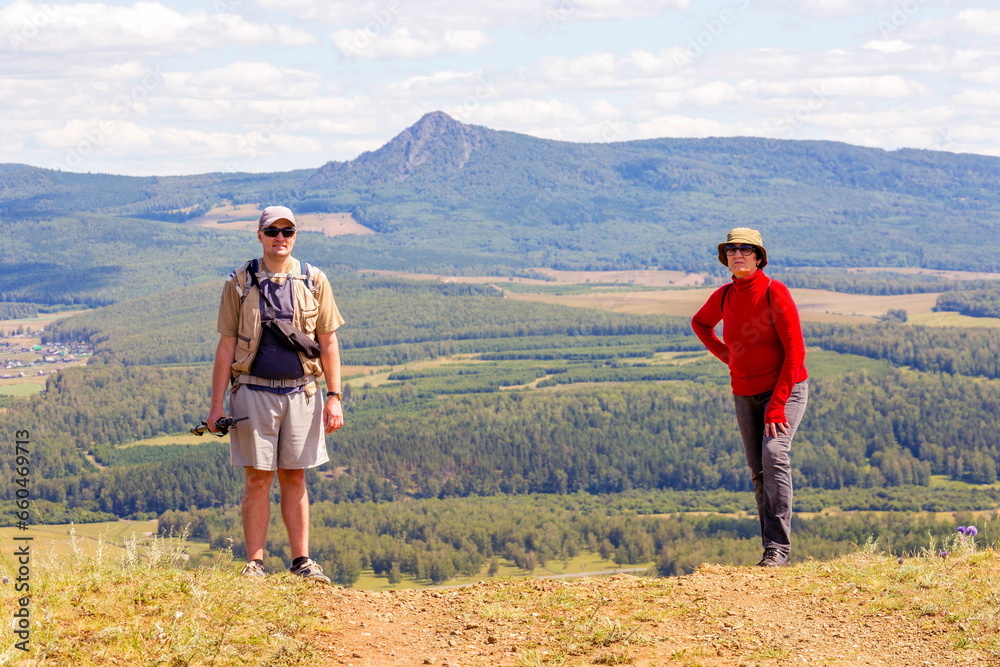 man and woman Tourists on a picnic on the ridge of the Ural Mountains on a summer sunny day