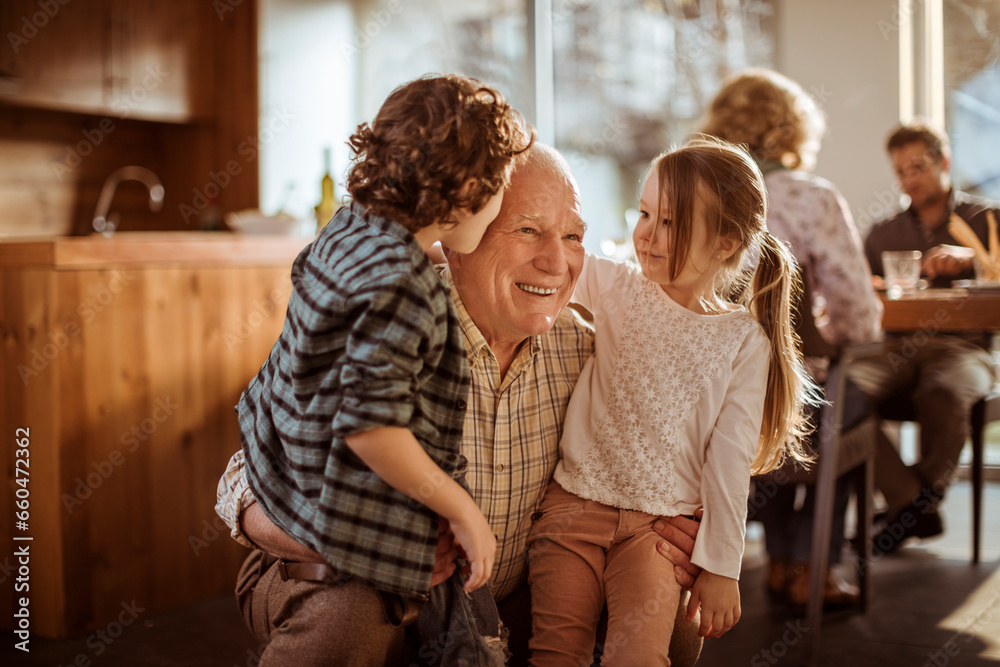 Grandfather embracing his grandchildren at home Grandfather embracing his grandchildren at home