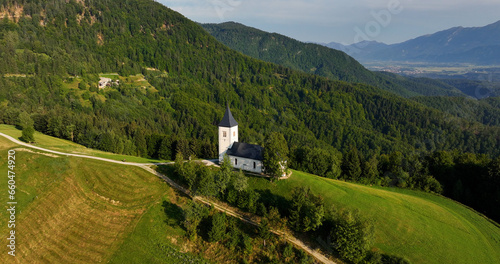 Slovenia, St. Primoz Church, Jamnik, majestic sunrise landscape from above, iconic Church on green hill in Kranj, Gorenjska