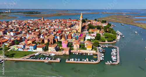 Aerial view of Burano Island, Church of Saint Martin Bishop, Campanile Pendente, colorful houses, fishing port, Veneto Region, Italy