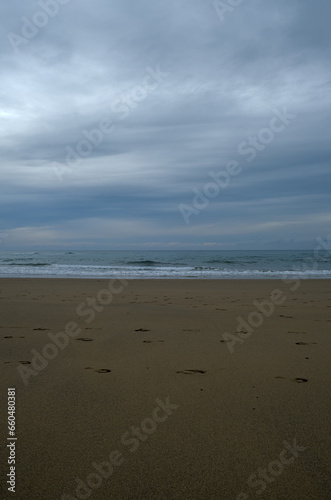View on a sandy coast of bay of Biscay with footprints