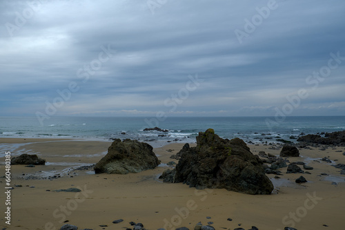 View on a sandy coast of bay of Biscay with large rocks