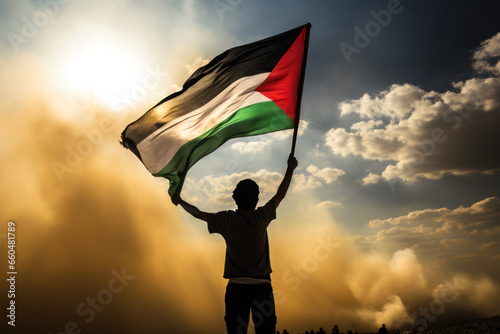 Happy man holding Palestine flag in the sunset sky, freedom and patriotism concept photo