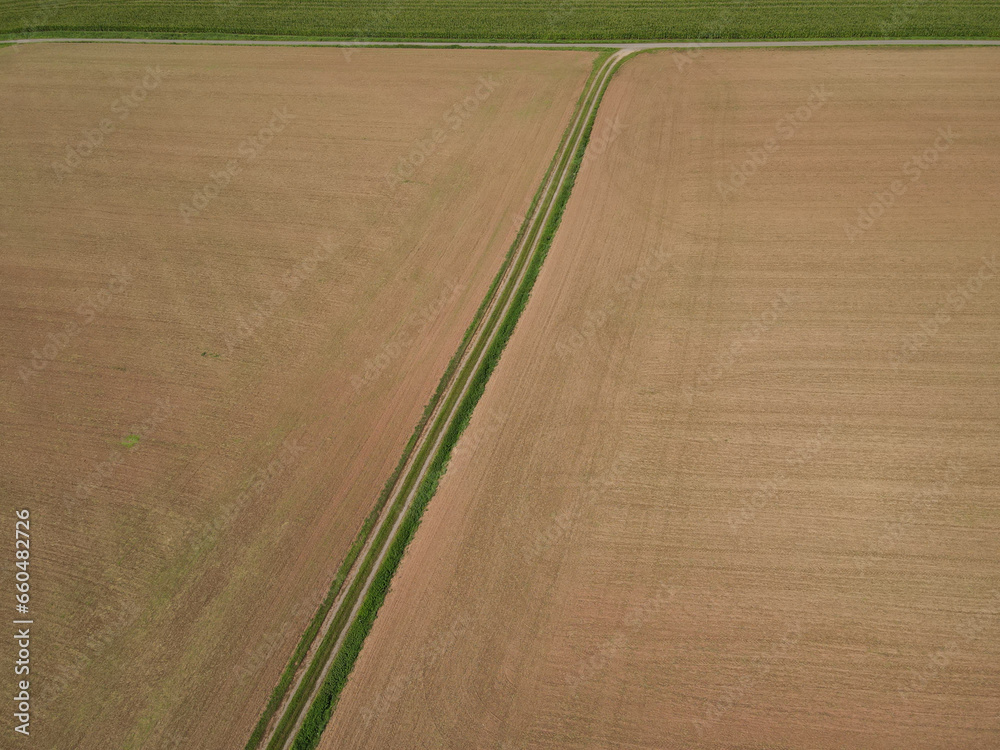 Brown agriculture fields with soil in the countryside from above 