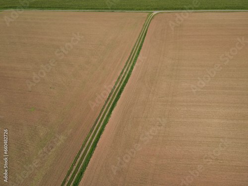 Brown agriculture fields with soil in the countryside from above 