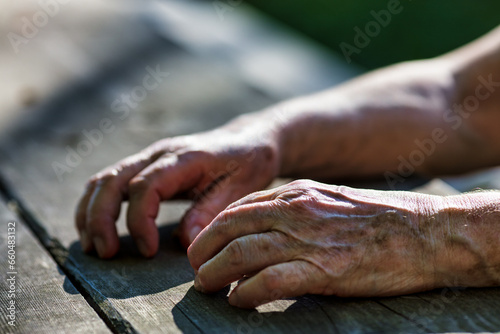 Elderly fingers, marked, find park solace