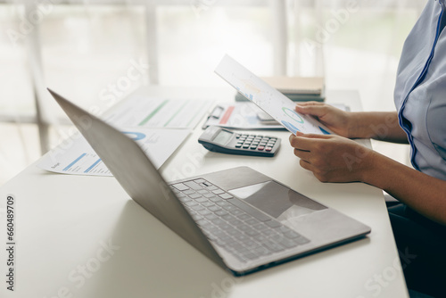 Auditor and accountant working in office Analyze financial data and accounting records with a calculator. Accounting companies provide financial and tax planning services. Close-up pictures photo