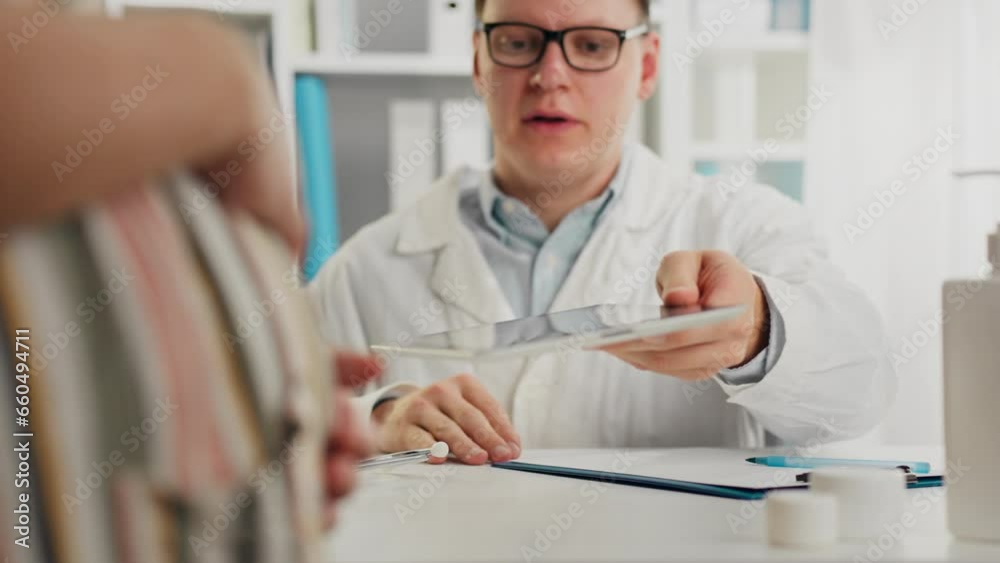 Pending. A patient in loungewear enjoys looking at a headshot of a baby in the office of an obstetrician-gynecologist. A young woman looks at the tablet screen care and concern for the fetus, uniform Pending. A patient in loungewear enjoys looking at a headshot of a baby in the office of an obstetrician-gynecologist. A young woman looks at the tablet screen care and concern for the fetus, uniform