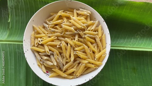 Weevils on spoiled pasta. Insects in food photo