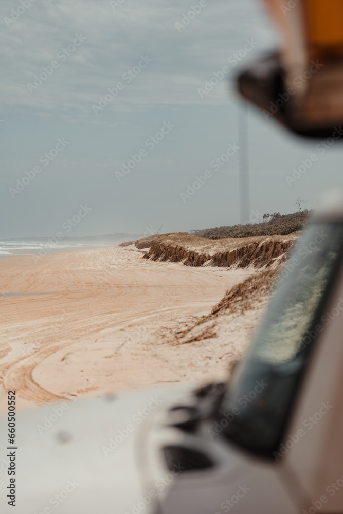 Looking past a 4WD to a sand dune and deserted Spit Fire Beach Looking past a 4WD to a sand dune and deserted Spit Fire Beach