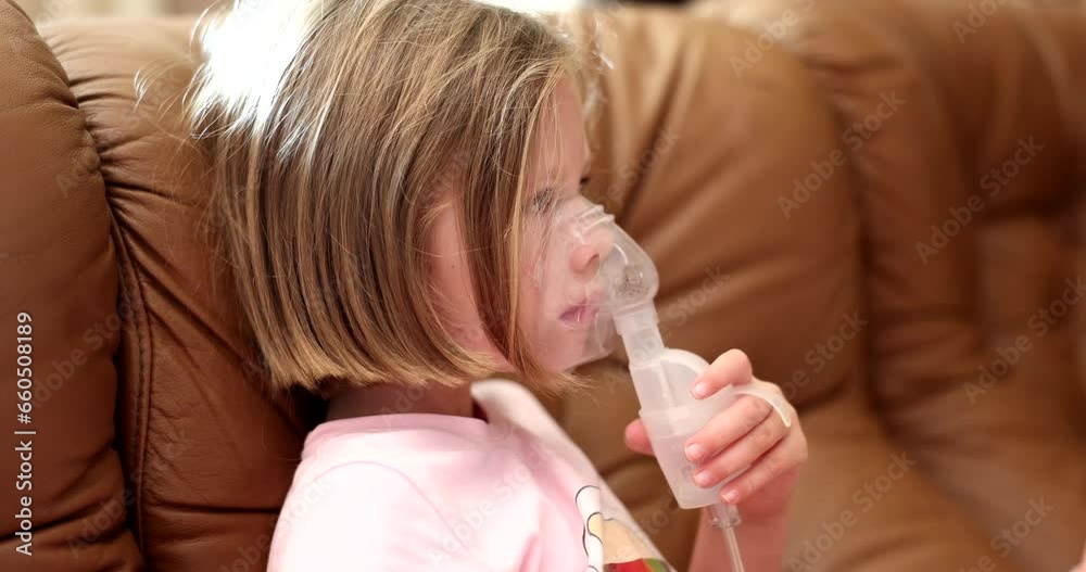 Sick child girl makes inhalation using nebulizer. Treatment of bronchitis cough and asthma in children Sick child girl makes inhalation using nebulizer. Treatment of bronchitis cough and asthma in children