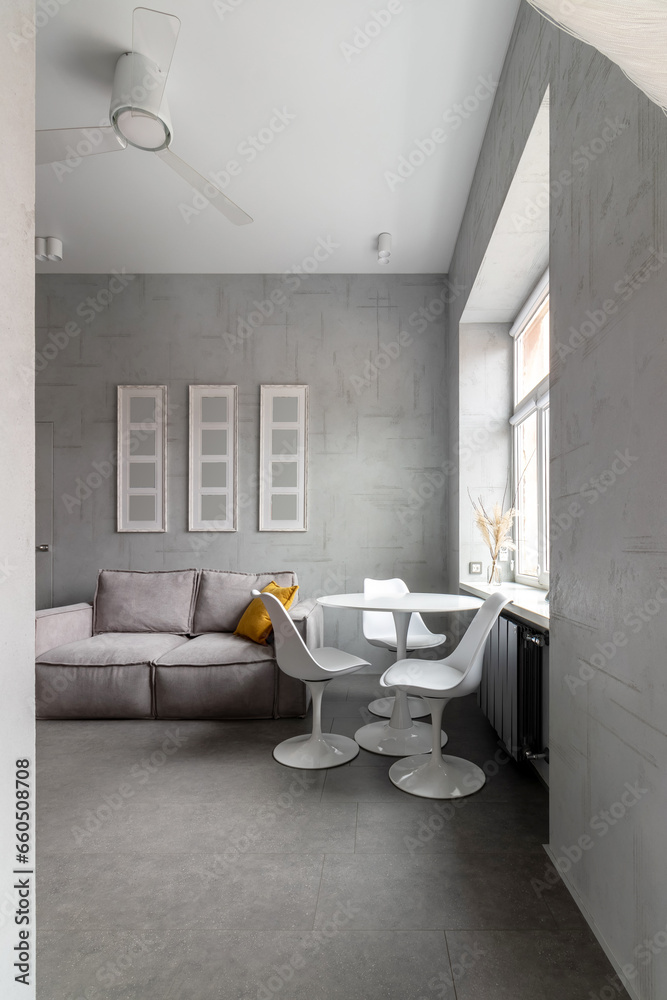 Apartment with white chairs and round wooden, white table Apartment with white chairs and round wooden, white table